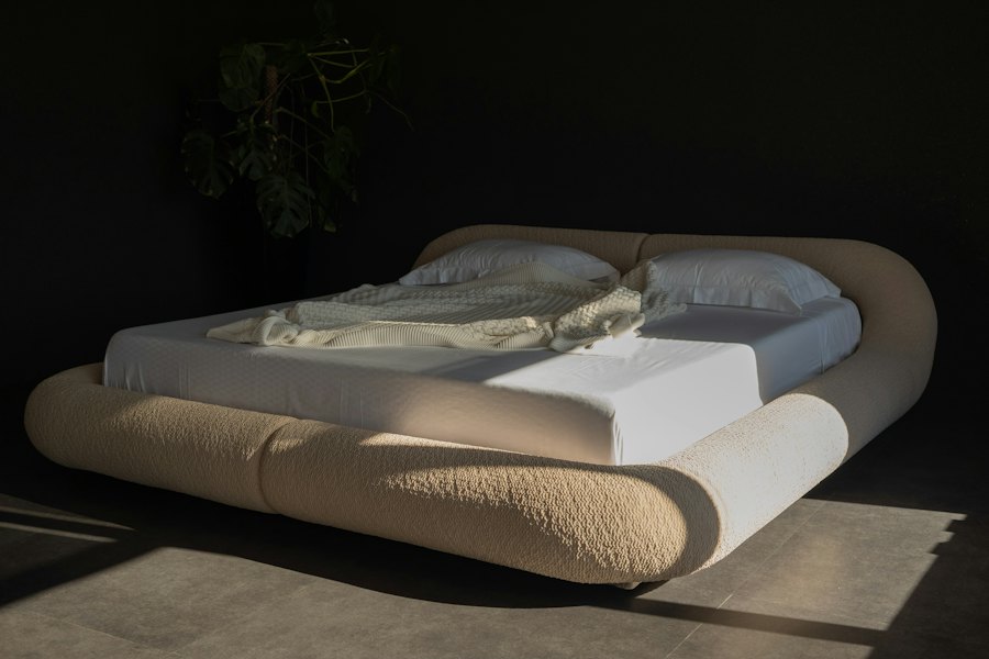 Neatly made bed with white linens
