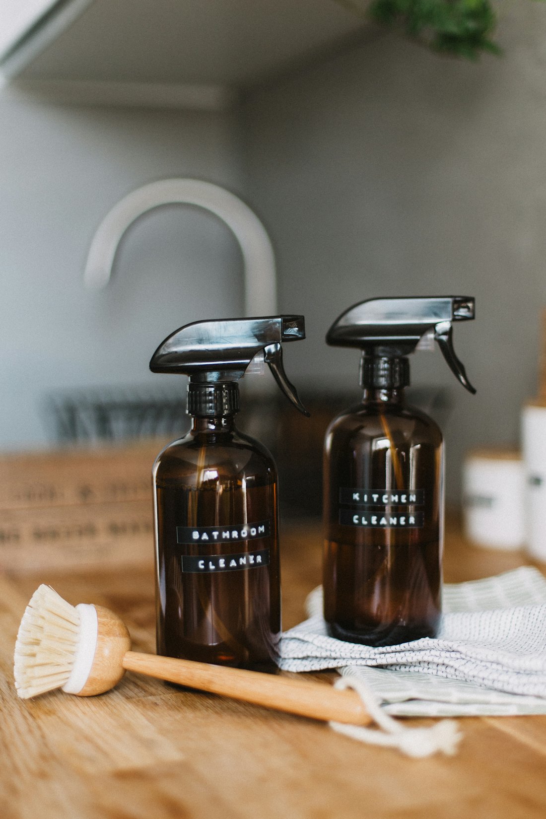 Amber glass spray bottles of plant-based cleaner